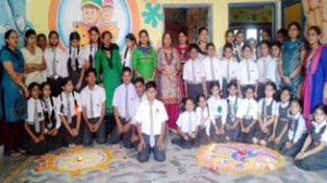 Students of New Rock Land Public School posing alongwith School Principal and staff members during Rangoli Making Competition on Monday.