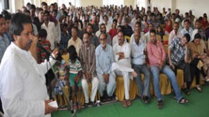 Minister for Housing, Raman Bhalla addressing a public gathering on Sunday.