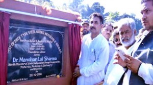 Minister of State for Fisheries, Dr Manohar Lal Sharma laying foundation stone of a bridge on Tuesday.