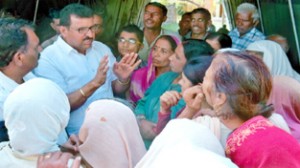 Ch Manmohan Singh, president, All India Jat Mahasabha, J&K interacting with the border migrants on Thursday.