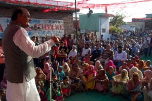 NC candidate for Vijaypur Assembly constituency, Surjit Singh Slathia, addressing a public meeting at Vijaypur on Sunday.