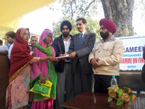 The official of J&K Grameen Bank disbursing amount to beneficiary under Self Help Groups on Thursday.