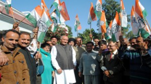 Congress candidate from Marh constituency, Balwan Singh, surrounded by party workers at his residence in Jammu.