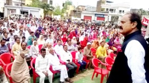 Surjit Singh Slathia addressing a public meeting in Vijaypur constituency on Friday.