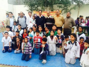 Budding players posing along with the chief guest Ashok Kumar and other dignitaries during inaugural ceremony of Taekwondo Championship. 