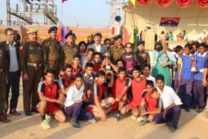 Winning team of Inter-State Volleyball Tourney posing with trophy and dignitaries at Jammu.