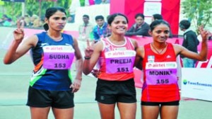 Indian women Preeja Sreedharan, Monika Athare and Sudha Singh-winners of the Airtel Delhi Half Marathon 2014 in New Delhi on Sunday.