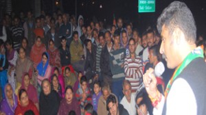 Pawan Khajuria addressing poll meeting at Ossu Kera on Sunday.