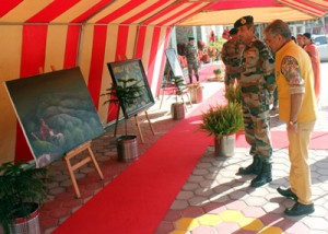 GOC-in-C Lt Gen D S Hooda looking at a painting during art training workshop.