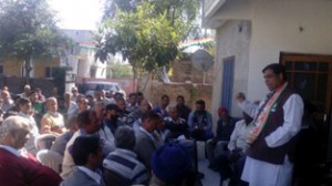 Cong candidate Ravinder Sharma addressing public meeting in Nowshera on Monday.