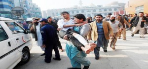 A man carries a student, who was injured during an attack by Taliban gunmen on the Army Public School, after he received treatment at a hospital in Peshawar on Tuesday. (UNI)