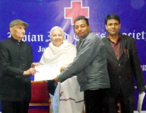 Participant of training programme receiving certificate from dignitaries.