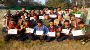 Young wrestlers holding certificates while posing for a group photograph alongwith dignitaries at Domana in Jammu on Friday.