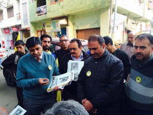 Dr Anil Kumar Dhar distributing leaflets during door-do-door campaign in Jammu West constituency.