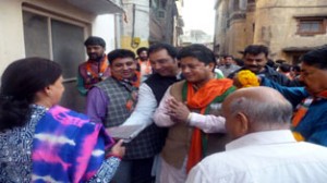 BJP candidate for Jammu East, Rajesh Gupta interacting with people during door to door campaign on Tuesday.