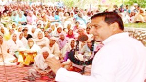 Minister for PHE, Irrigation and Flood Control, Sham Lal Sharma addressing a public meeting in Akhnoor constituency.
