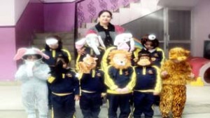 Little kids in fancy dresses posing for photograph during Poetry Recitation Competition at Little Millennium Preschool.