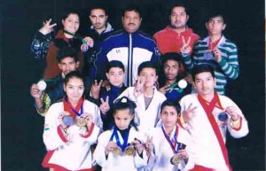 Medal winners of 10th National Taekwondo Championship posing for a group photograph.    