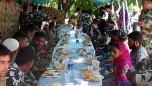 People enjoying bandhara organised  by CRPF on Friday.