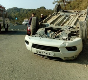 Overturned car on National Highway near Flata on Tuesday.
