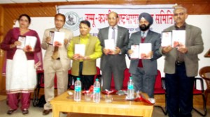 Divisional Commissioner Shantmanu and others releasing a collection of poems by Prof Raj Kumar on Sunday.