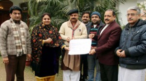 Yudhvir Sethi, BJP leader and Party Mahila Morcha chief, Priya Sethi handing over a cheque to Union Minister in PMO, Dr Jitendra Singh on Saturday.