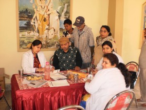 Doctor examining patients during medical camp at Jammu on Monday.