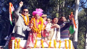 Minister of State for Finance, Dr Manohar Lal Sharma during a road show at Billawar on Sunday.
