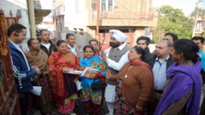 Congress candidate for Jammu West constituency during door-do-door election campaign.