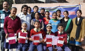 Winners of debate competition organized by DIC posing alongwith prizes and certificates at Udhampur.