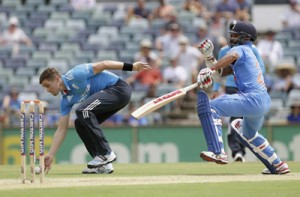 England's Chris Woakes attempts unsuccessfully to run out India's Shikhar Dhawan during One Day International (ODI) tri-series cricket match at the WACA ground in Perth, Australia on  Friday.