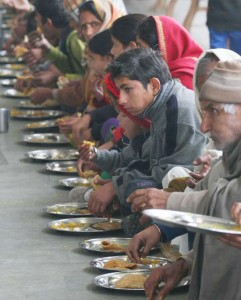 People displaced from the border villages after Pakistani shelling, eating at a relief camp at Samba on Tuesday. 