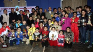 Winners and runners-up shuttlers of J&K State Badminton Championship posing for a group photograph along with the dignitaries in Jammu on Saturday.-Excelsior/Rakesh