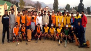 Winners of the opening match of the Junior Boys Hockey Championship posing for a group photograph along with dignitaries and officials in Poonch on Monday.