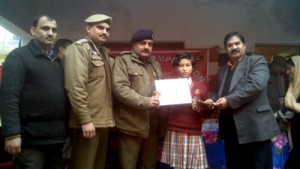 SDPO East Mohammad Rafiq giving away prize to topper of painting competition.