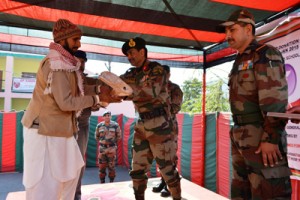 General Officer Commanding, Romeo Force presenting an artificial limb to a disabled person at Rajouri. 