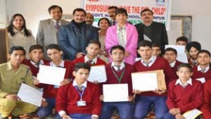 Participants alongwith dignitaries posing for group photograph during symposium on Saturday.