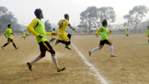 Players in action during football match at GGM Science College ground.