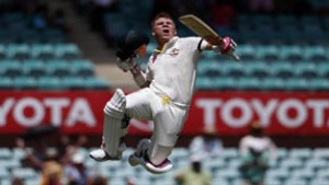 Australia's David Warner celebrates reaching his century during the first day's play in the fourth test against India at SCG.(UNI)