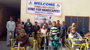 Beneficiaries during two days camp for tricycles distribution at Jammu on Tuesday. 