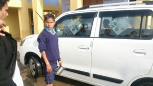 Student washing teacher’s car at Govt Middle School, Rathana in R S Pura on Thursday.