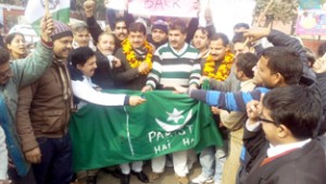 JKNPP activists burning Pakistan flag during a protest demonstration in Jammu on Tuesday