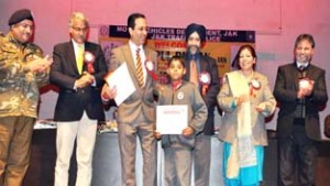 Commissioner Secretary, Bipul Pathak and others giving prize to a participant at Jammu on Saturday.