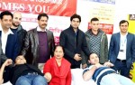 Volunteers donating blood during a camp at Bahu Plaza in Jammu.