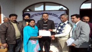 MLA Marh, Sukhnandan Chowdhary, presenting certificate to a student during function at Phallain Mandal in Jammu on Saturday.