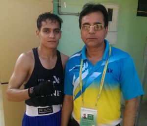 J&K Boxer Pardeep Sharma posing for photograph with Coach Anil Kumar Wadhera at Kerala on Monday. 