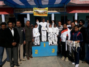 Winners posing along with the chief guest and guest of honour on inaugural day of 2nd State Sambo Championship in Jammu. 