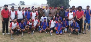 Jubilant winners of the hockey title posing along the chief guest and other dignitaries at Simbal Camp in Jammu on Sunday.
