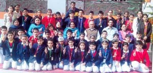 Students of Nav Yug School alongwith staff posing for a group photograph during Annual Sports Day on Saturday.