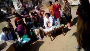 Doctor examining patients during free medical camp.